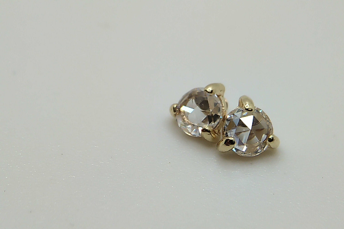Pair of clear faceted gemstone jewelry ends in gold settings