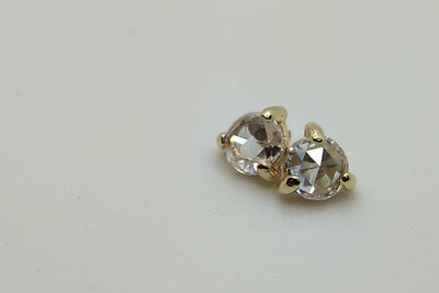 Pair of clear faceted gemstone jewelry ends in gold settings