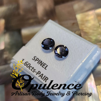 Pair of dark spinel jewelry ends on a gemstone display card