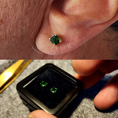 Green gemstone stud worn in an earlobe piercing