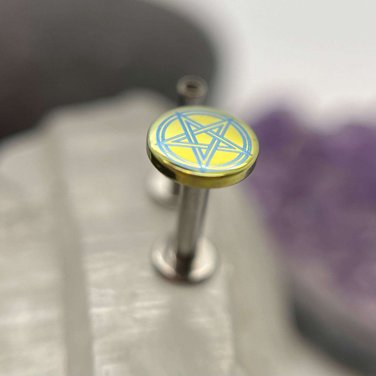 Yellow and blue titanium pentagram disc on a flat-back post