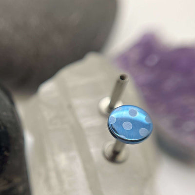 Blue titanium disc with pale blue polka dots on a flat-back post