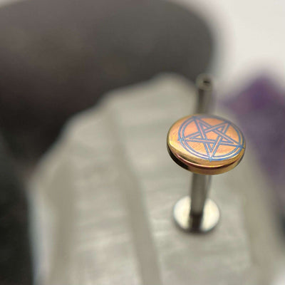 Peach and purple titanium pentagram disc on a flat-back post