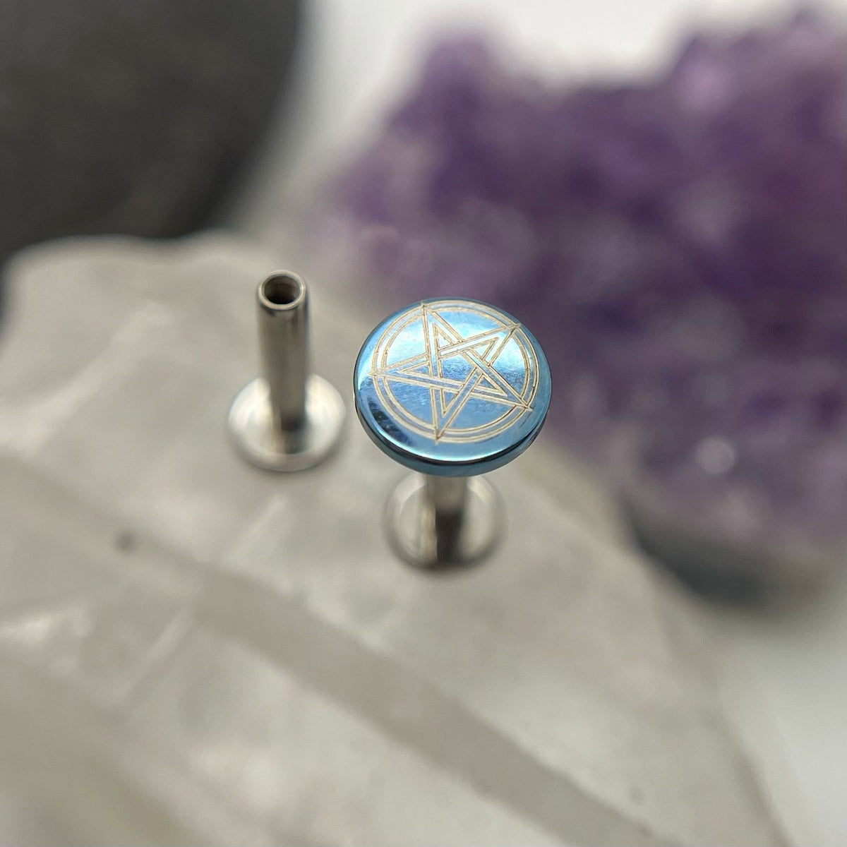 Blue titanium pentagram disc mounted on a flat-back post