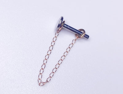Fine gold chain looped around a polished jewelry post