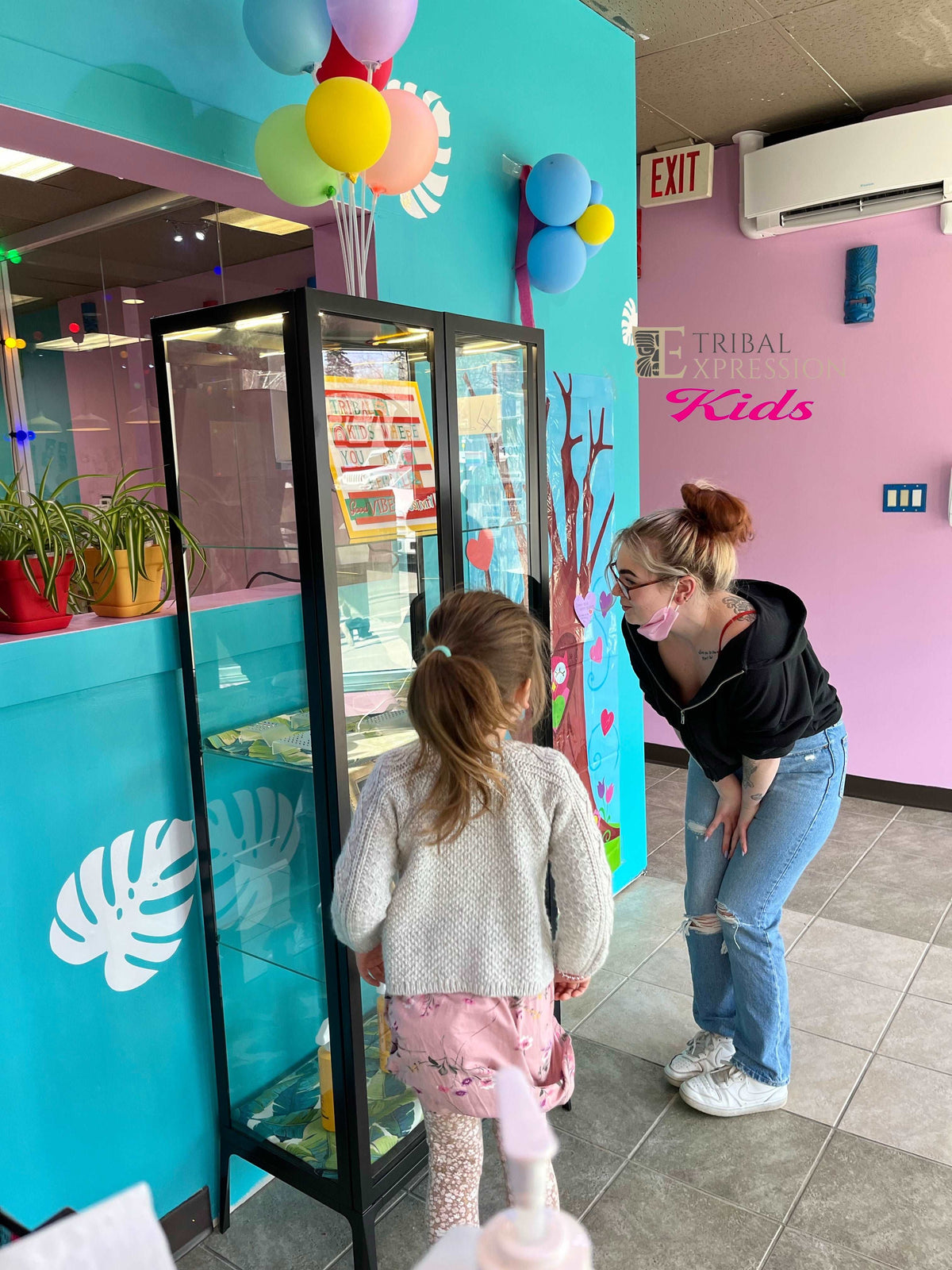 Piercer speaking with a child at the Tribal Expression Kids studio