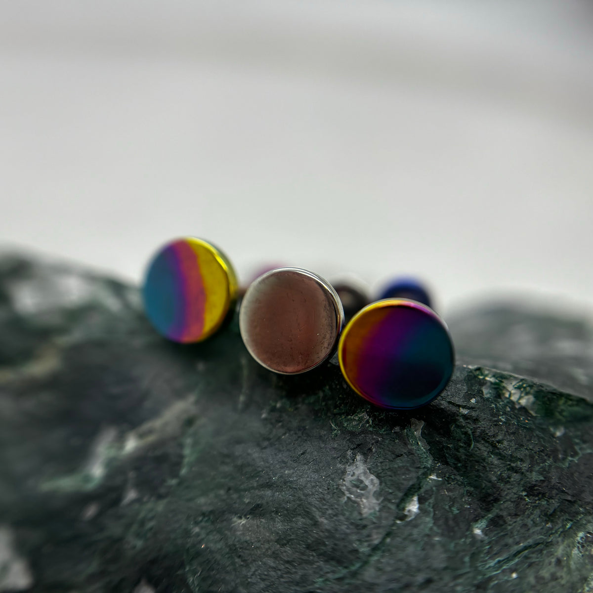 Round titanium disc ends with bronze and rainbow anodized finishes