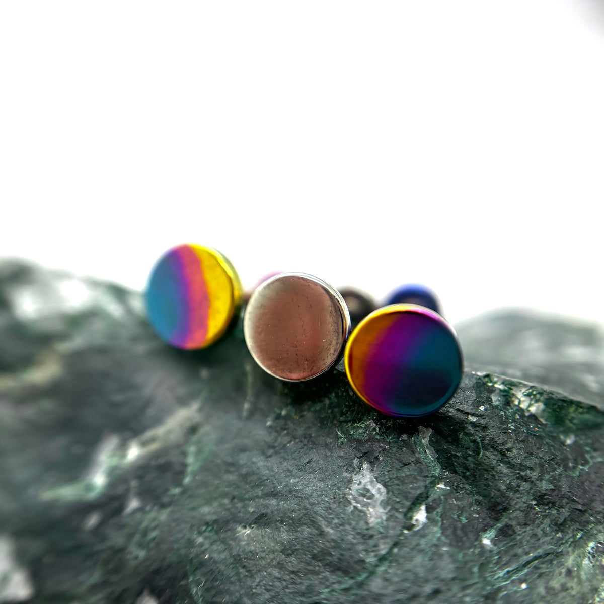 Round titanium disc ends with bronze and rainbow anodized finishes