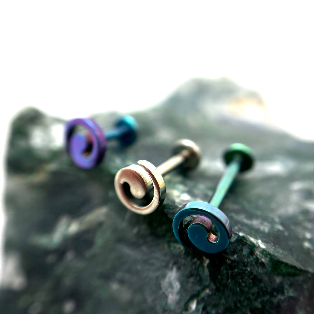 Spiral-shaped titanium jewelry ends in assorted anodized colours