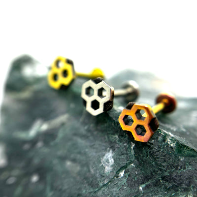 Honeycomb-shaped titanium ends in gold, polished and copper-toned finishes