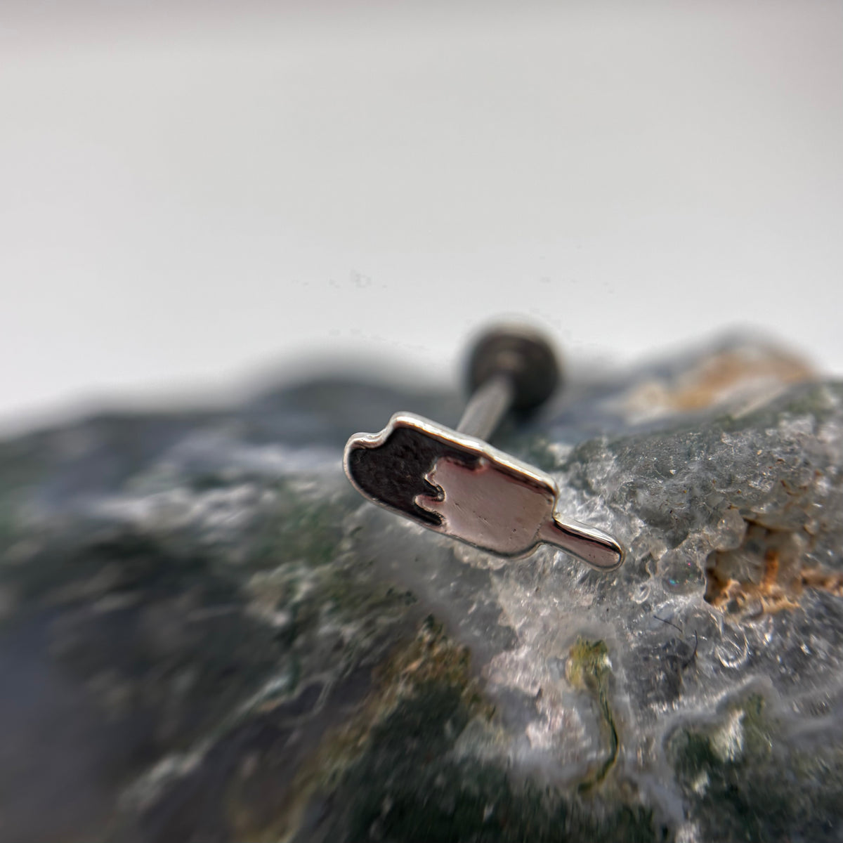 Silver popsicle-shaped jewelry end on a flat-back post