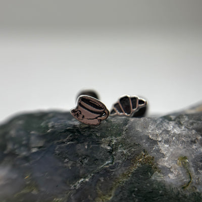 Silver espresso cup and croissant jewelry ends on stone