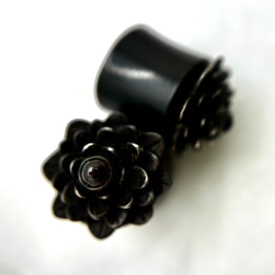 Dark wood double-flare plugs with layered flower-shaped fronts
