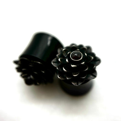 Dark wood double-flare plugs with layered flower-shaped fronts