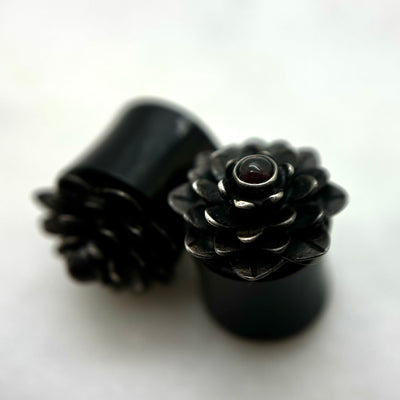 Dark wood double-flare plugs with layered flower-shaped fronts