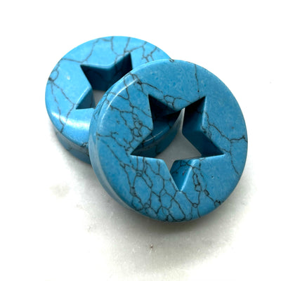 Pair of blue synthetic turquoise plugs with star-shaped cutouts