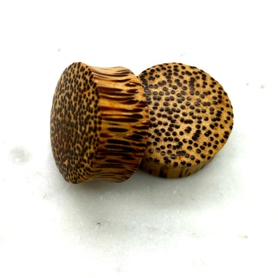 Wood plugs with a speckled golden-brown grain