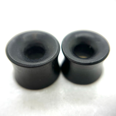 Dark wood tunnels with flared rims and circular openings