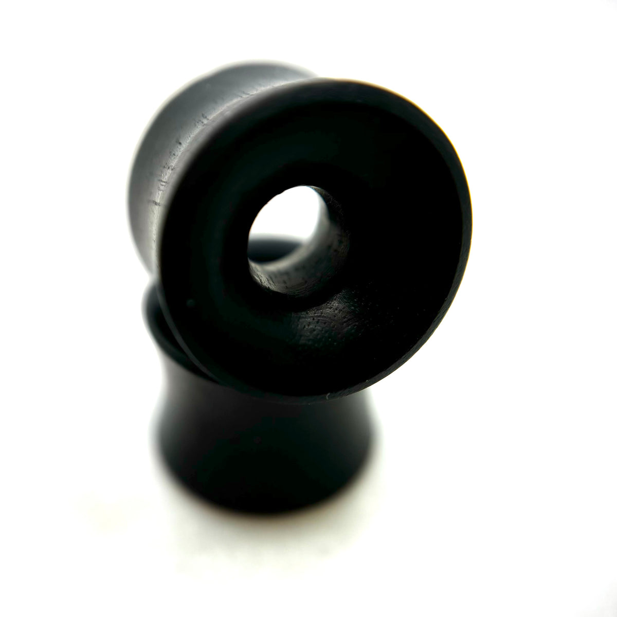 Dark wood tunnels with flared rims and circular openings