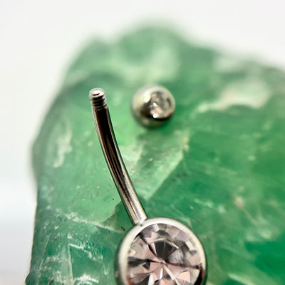 Stainless steel navel bar with a clear gemstone and a removed top bead