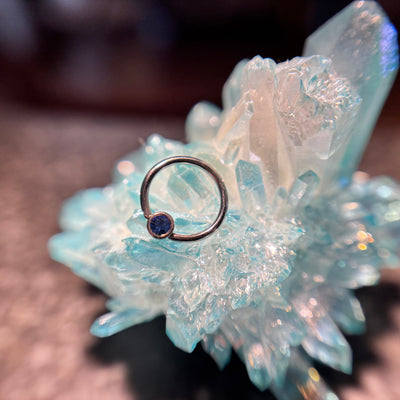 Titanium fixed-bead ring with a blue-purple bead on blue crystal