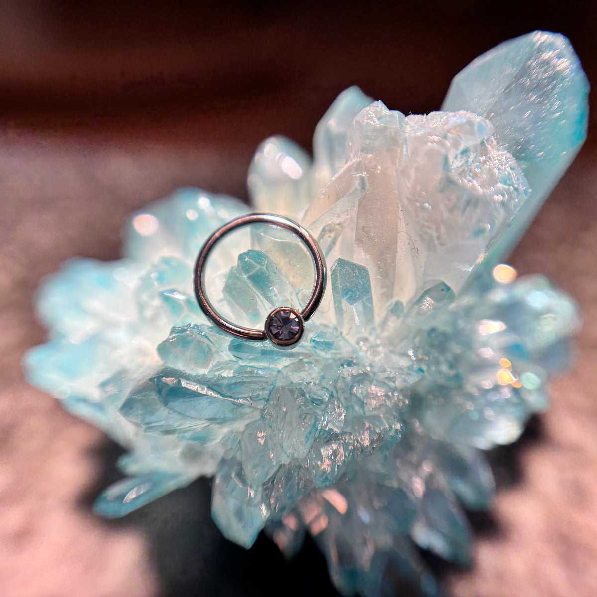 Titanium fixed-bead ring with a blue-purple bead on blue crystal