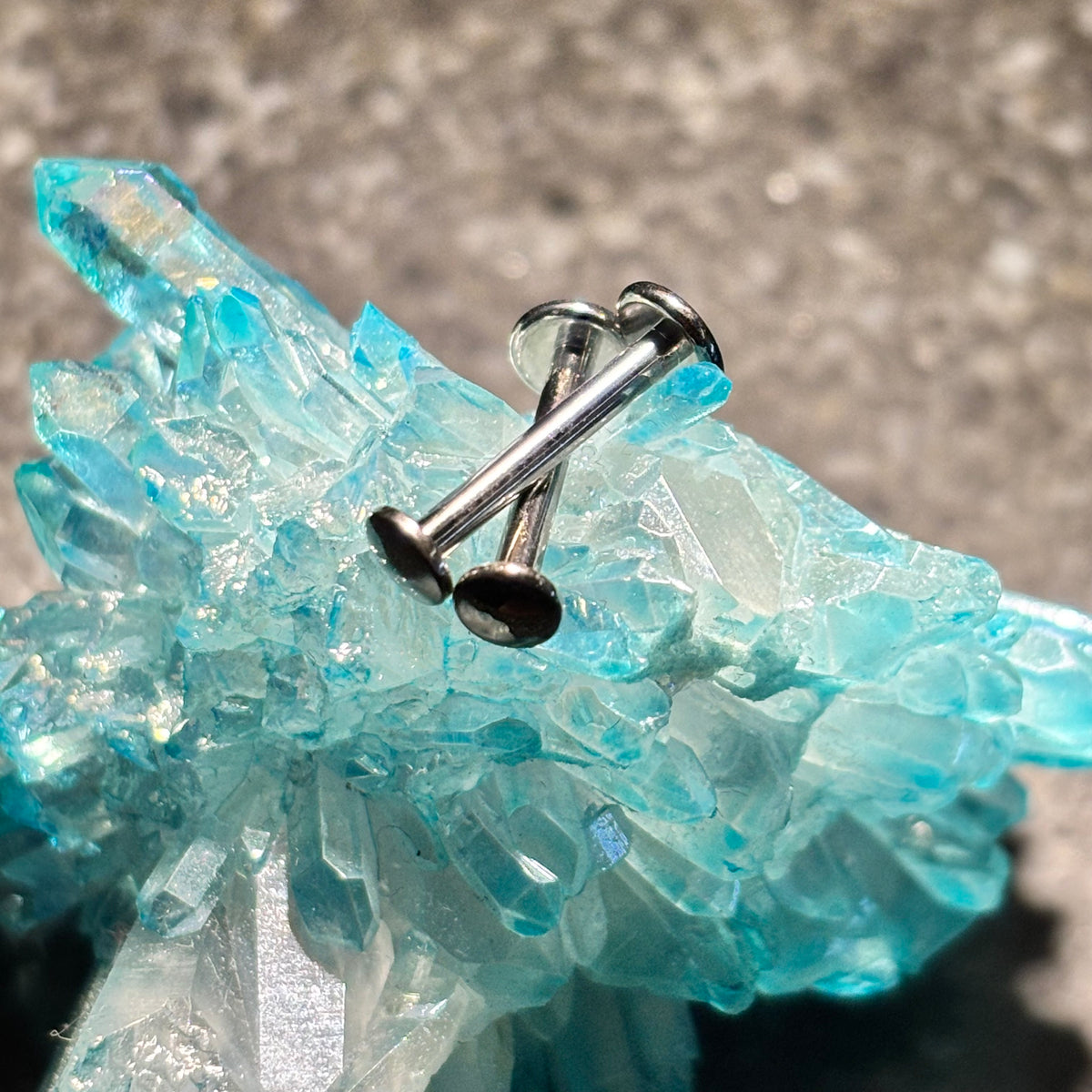Flat-back jewelry posts with stainless steel disc ends on blue crystal