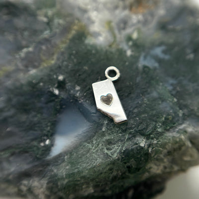 Silver Alberta-shaped charm with a heart cutout and attachment loop