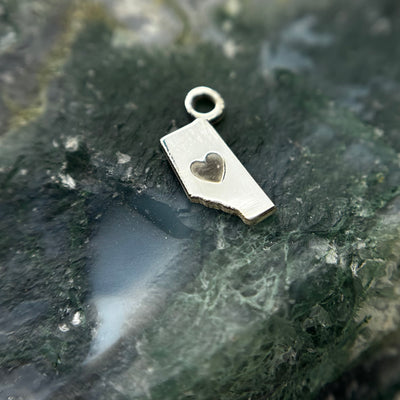Silver Alberta-shaped charm with a heart cutout and attachment loop