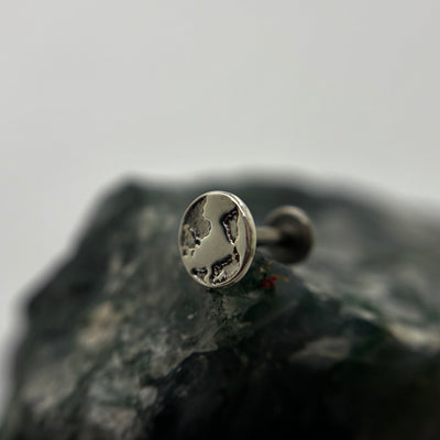Silver Earth-shaped threadless end with engraved continents on a flat-back post