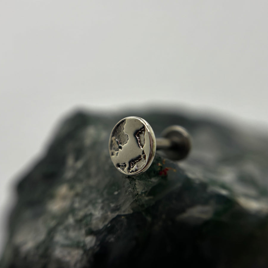 Silver Earth-shaped threadless end with engraved continents on a flat-back post
