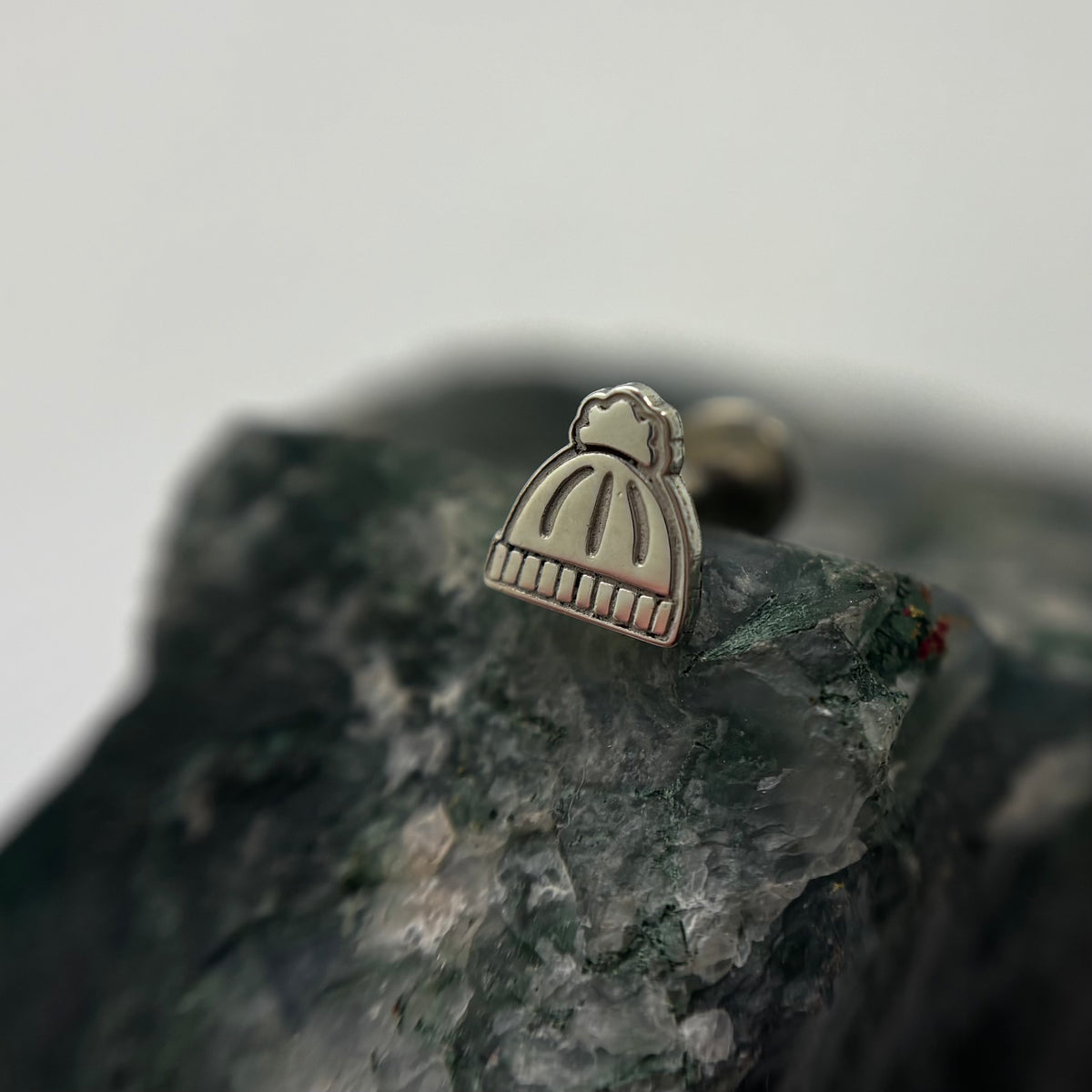 Silver knit beanie-shaped jewelry end on a flat-back post