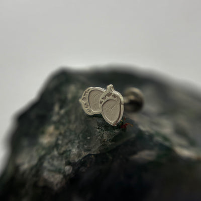 Silver acorn-shaped jewelry end on a flat-back post