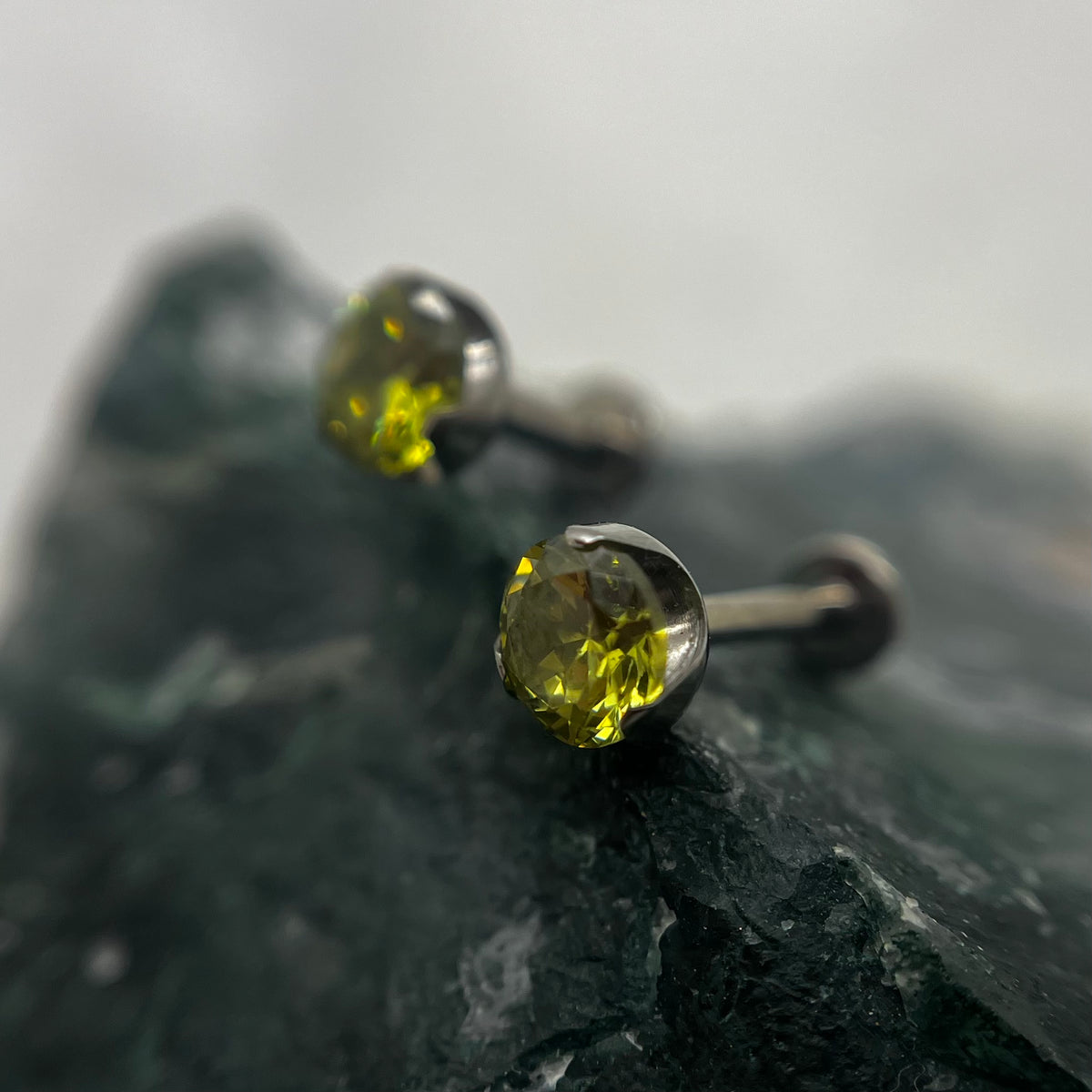 Olive green cubic zirconia titanium ends on flat-back posts