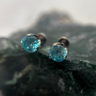 Aqua cubic zirconia titanium ends on flat-back posts