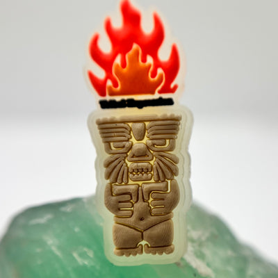 Tribal Expression shoe charm with a red flame and carved-face design