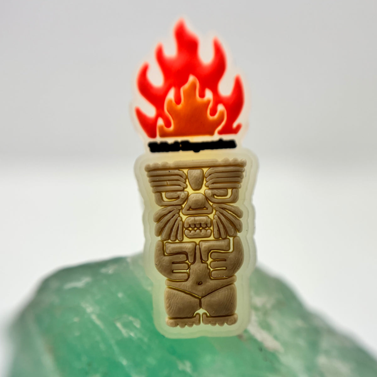 Tribal Expression shoe charm with a red flame and carved-face design