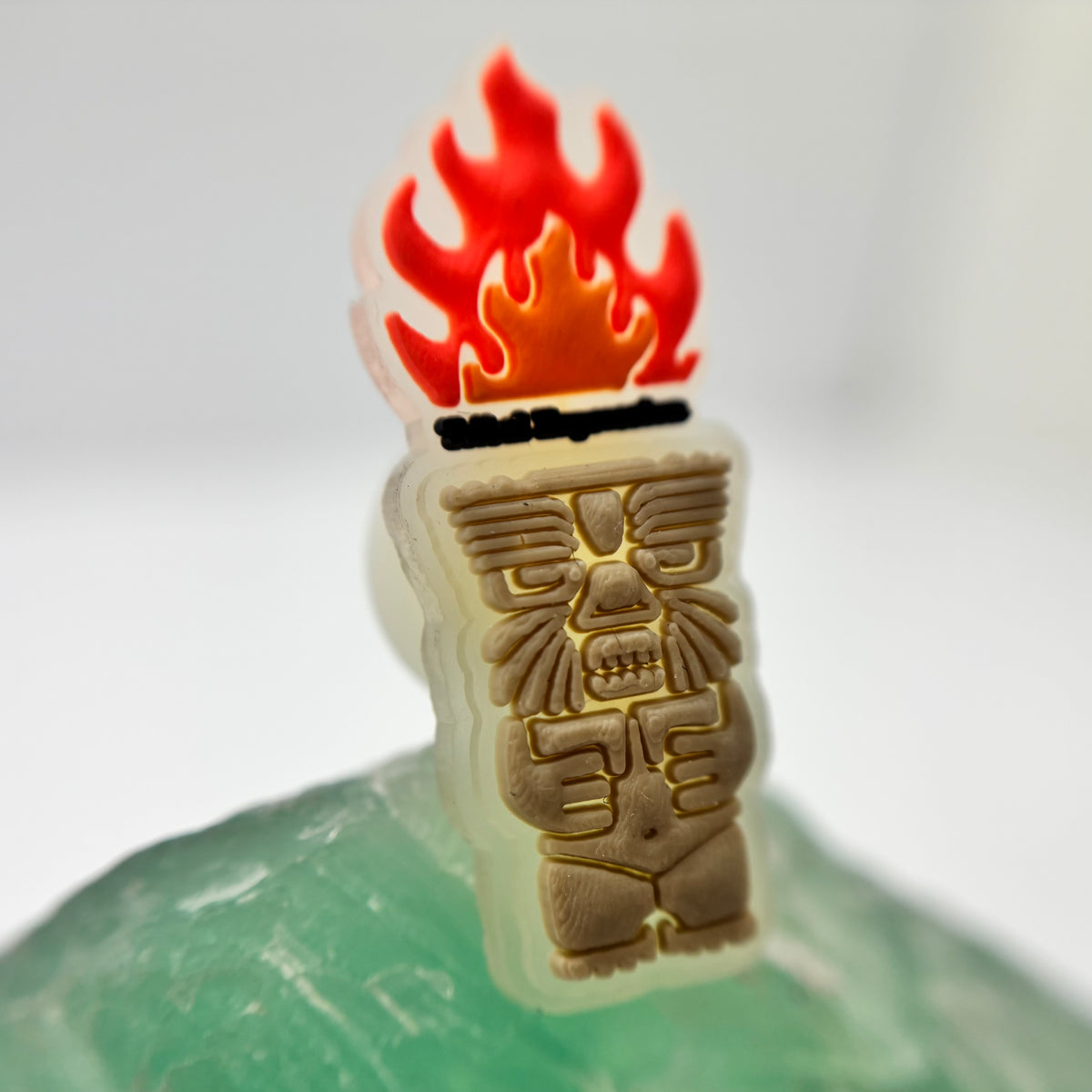 Tribal Expression shoe charm with a red flame and carved-face design