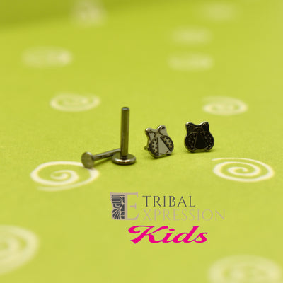 Ladybug-shaped titanium jewelry ends beside a flat-back post