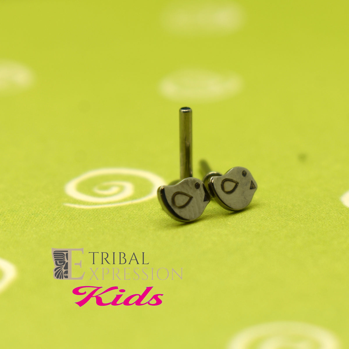 Duck-shaped titanium jewelry ends beside a flat-back post