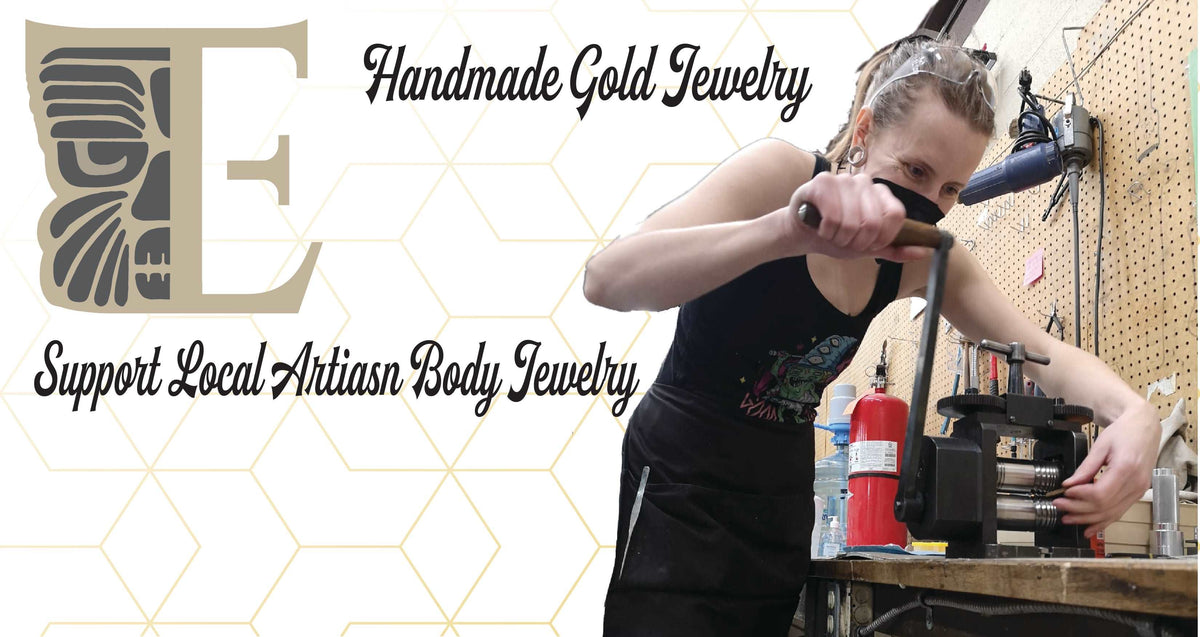 Jewelry maker working at a bench beside a handmade gold jewelry message