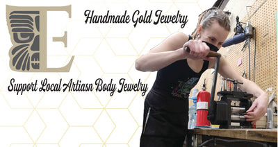 Jewelry maker working at a bench beside a handmade gold jewelry message