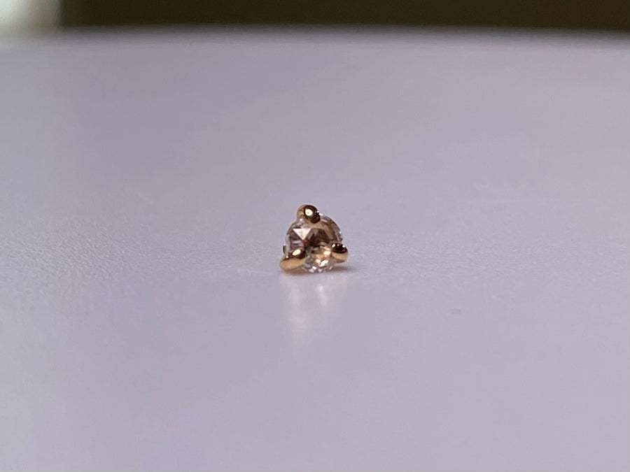 Rose-cut diamond jewelry end in a three-prong rose gold setting