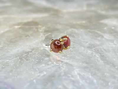 Yellow gold garnet cabochon ends with threadless pins visible
