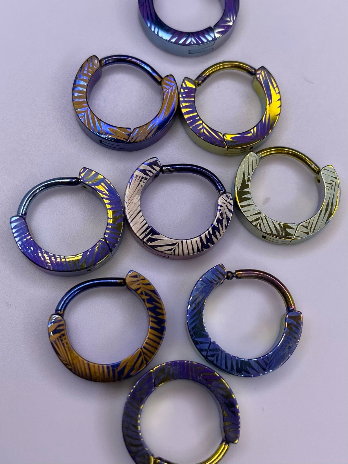 Palm Leaf titanium clickers in assorted anodized colours