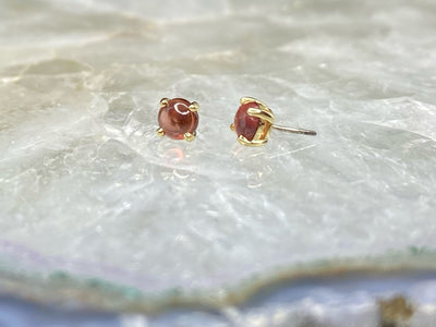 Yellow gold garnet cabochon ends with threadless pins visible
