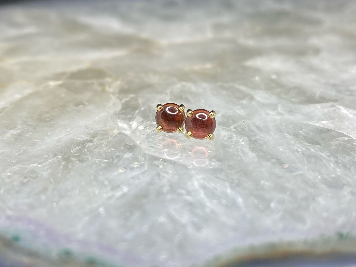 Pair of red garnet cabochon ends in yellow gold settings