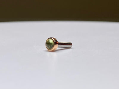 Rose gold threadless stud with a green peridot cabochon