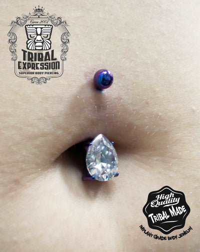 Clear teardrop gemstone titanium jewelry worn in a navel piercing