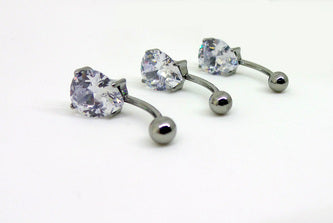 Polished titanium navel bars with clear teardrop gemstones